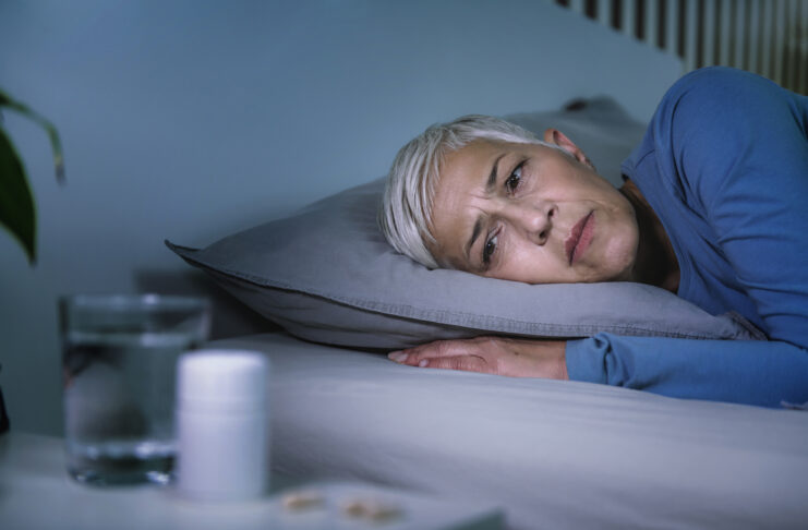 Insomnia and sleeping pills that do not work. Mature woman with sleeping problems awake in the middle of the night Why You Wake At 3AM